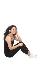 Naklejka premium cute hispanic girl smiling while listening to music on headphone