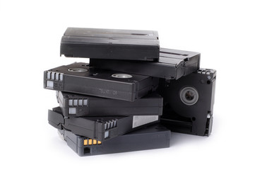a few stacked used Hi-8 video tape with white background
