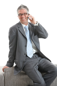 Happy businessman with mobile