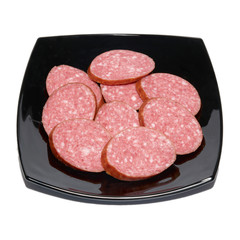 Sliced sausage on black plate