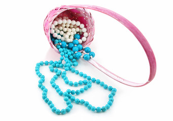 Colored Pearl Beads in Pink Wicker Basket Isolated