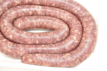 Raw sausage on tray.