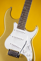 Fototapeta na wymiar Guitar gold Metallic Isolated on Yellow