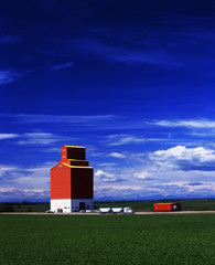 Truck drives away from grain elevator