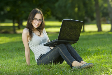 student with laptop outdoors