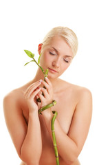 Beautiful young woman with a bamboo plant