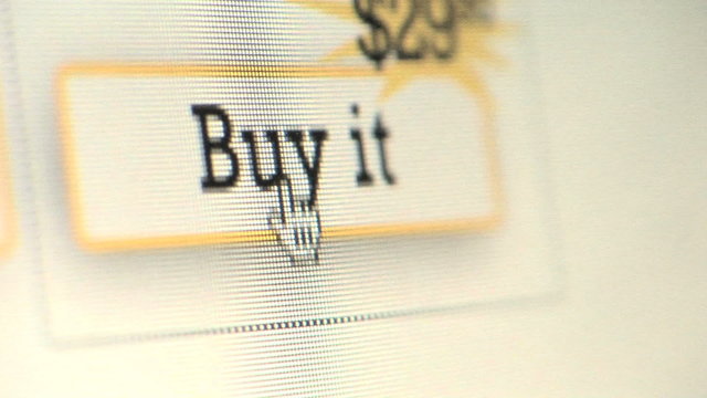Cursor clicking on Buy It button on computer monitor