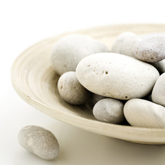 pebbles in bamboo bowl