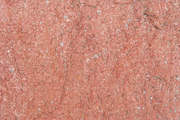 Natural red stone surface covered by moss