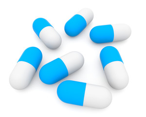 Blue-white pills on white background