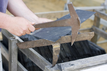 roofer cut a slate on a stack