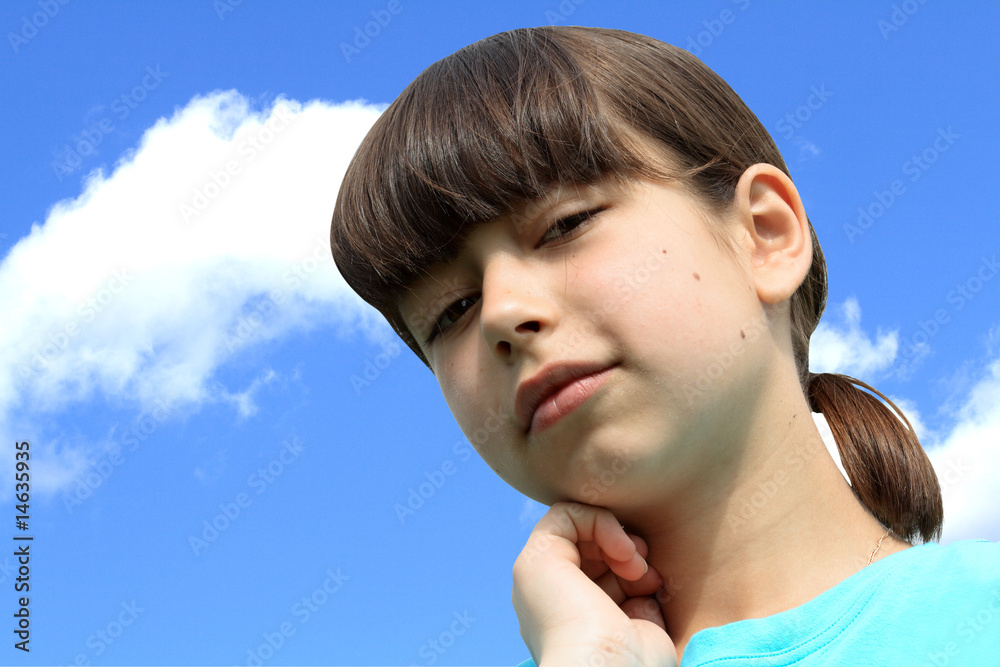 Wall mural close-up of young nice girl on sky background