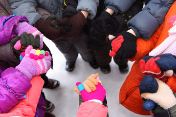 Children stand around having joined hands,  top view