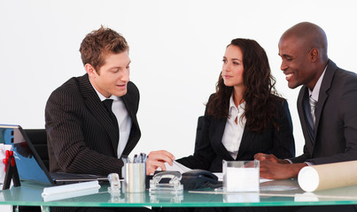 Three business people interacting in a meeting