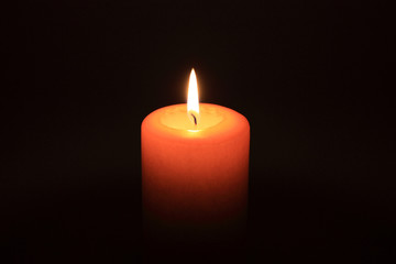 Candle glowing in the dark