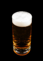 Glass with beer and froth isolated on black