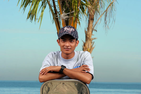 man on the chair with beach at background