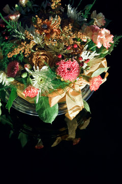 Flower Bouquet with ribbon on reflecting black background