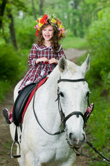 Laughing little girl in floral wreath