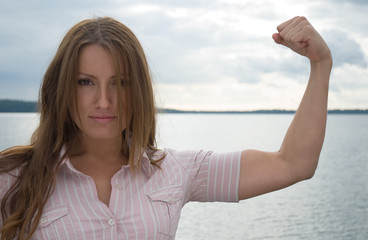 Fototapeta na wymiar Young businesswoman with strong arm