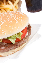 cheeseburger, french fries and cola on white background