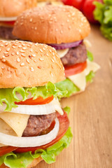 cheeseburger, with ingredients on wooden table