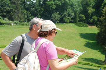 senior tourists reading a map