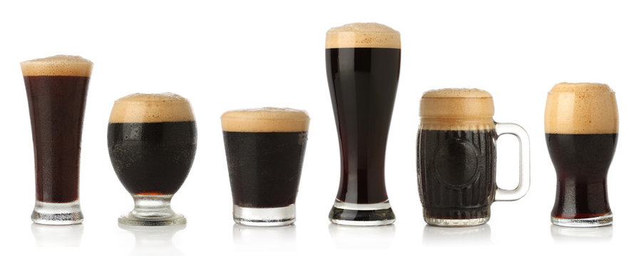 Differente glasses of stout beer, isolated on white