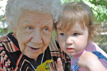 grandmother tells a fairy tale to the grand daughter