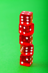 Red dice against green background - shallow DOF