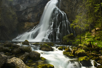Obraz premium big waterfall with rapids in the alps