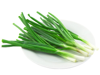 Green onion on white plate. Isolated