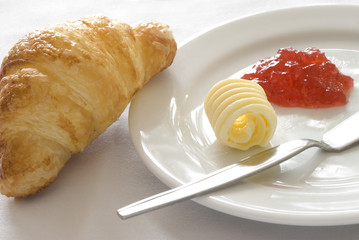 Croissant with butter and jam