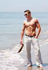 Handsome man standing on beach