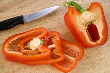 Red Pepper on chopping board with knife