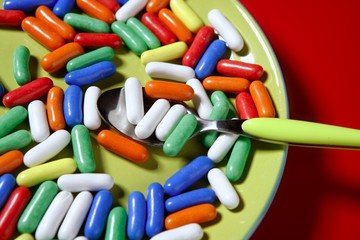 colorful candy on vivid red background