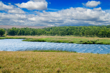 lagoon of small lake with cloud on the sky and strong waves