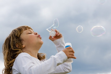 blowing soap bubbles