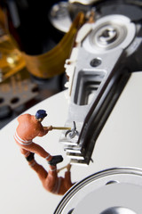 Worker figurine on hard drive