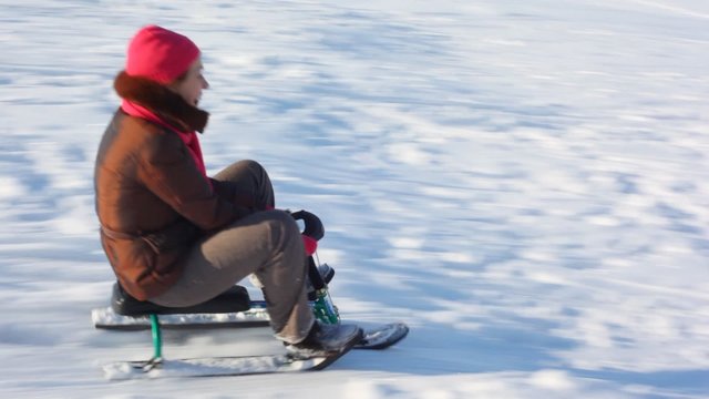 Mother and son ride with mountains on sled