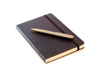Black leather-bound notebook with pen
