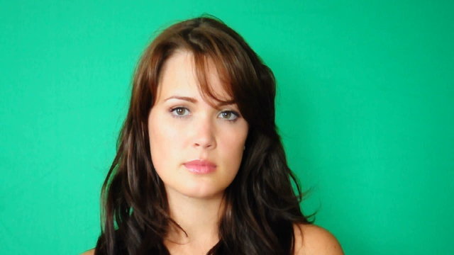 HD720p Young sexy brunnete woman looking on green background