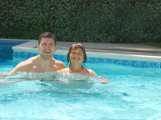 Dad and Son Enjoying Swimming Pool