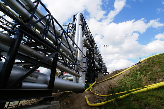industrial pipelines on pipe-bridge against blue sky