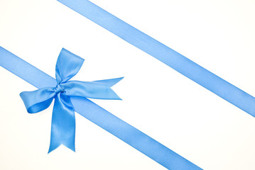 Gift packaging with blue ribbons and bow isolated on white