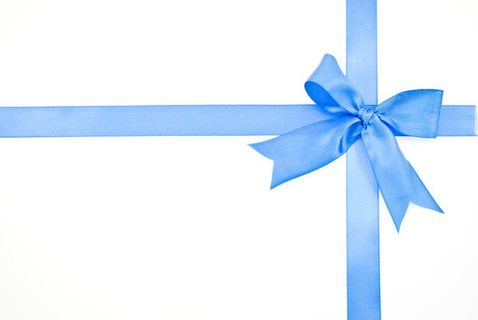 Gift packaging with blue ribbons and bow isolated on white