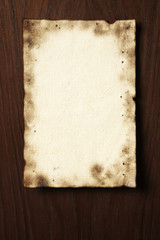 Grunge parchment on wooden board