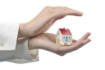 Women's hands with a little house