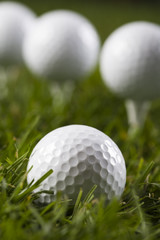 Golf ball on tee in grass