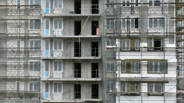 Builders work on exteriors of the building